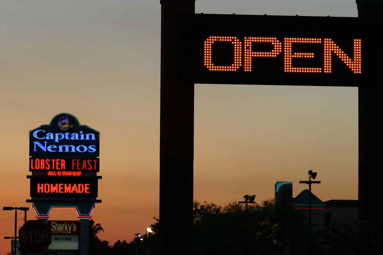 team-02 Neon signs light up the evening sky in Kissimmee, Florida. Vibrant nightlife is evident.